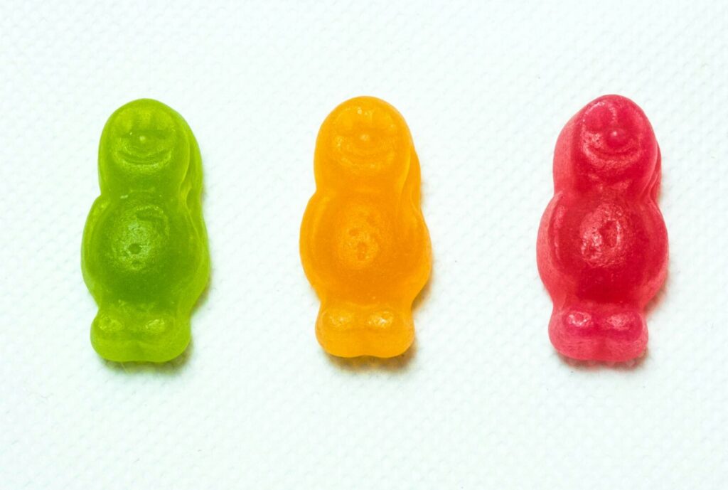 Image of three gummy bear sweets, green, amber and red. | M&A M and A SNP