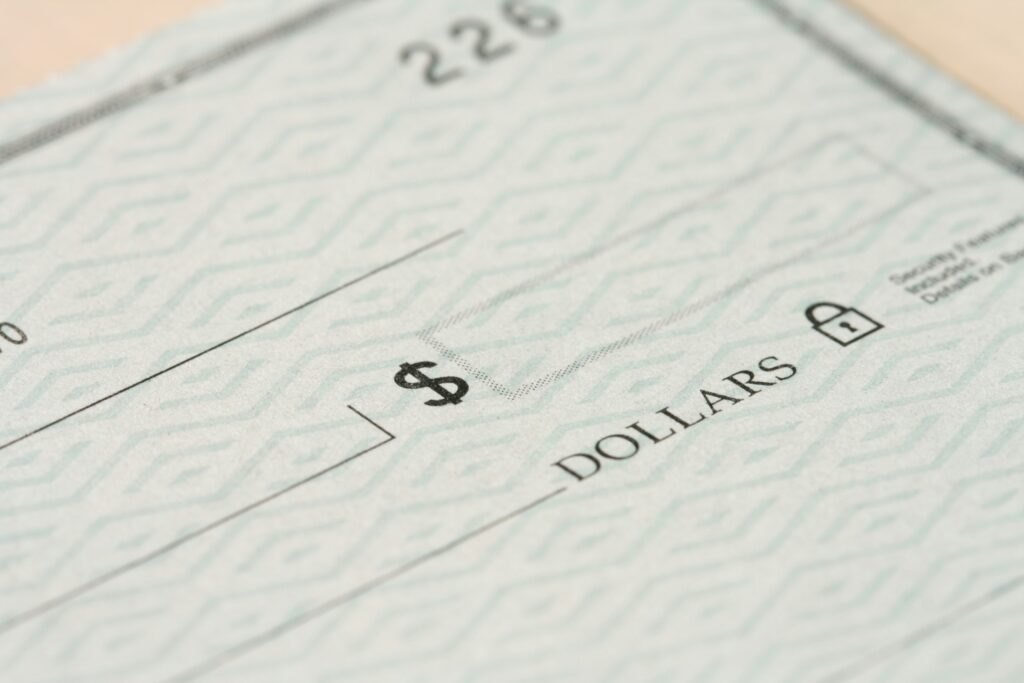 photo of a dollar cheque | CloudRock consulting services and practice for global payroll implementations