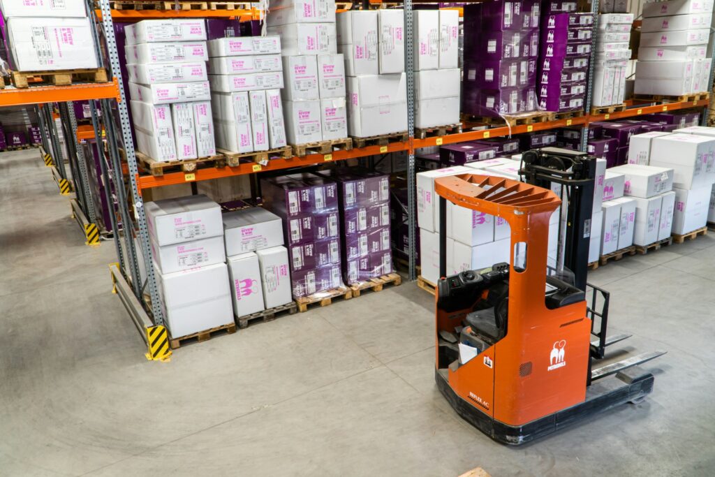 image of warehouse and orange forklift | inventory