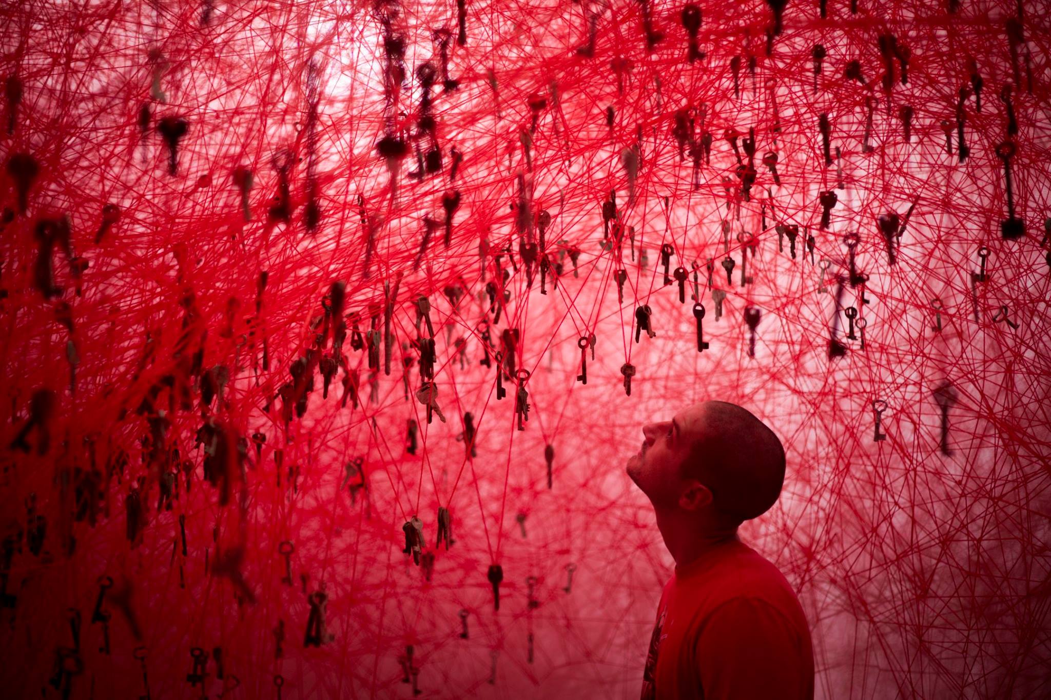 Image of a red Person looking up at a tangled web of string with different keys hanging throughout. | Accelalpha Oracle implementation