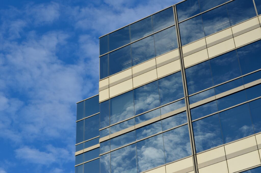 an high office building with clouds in the background