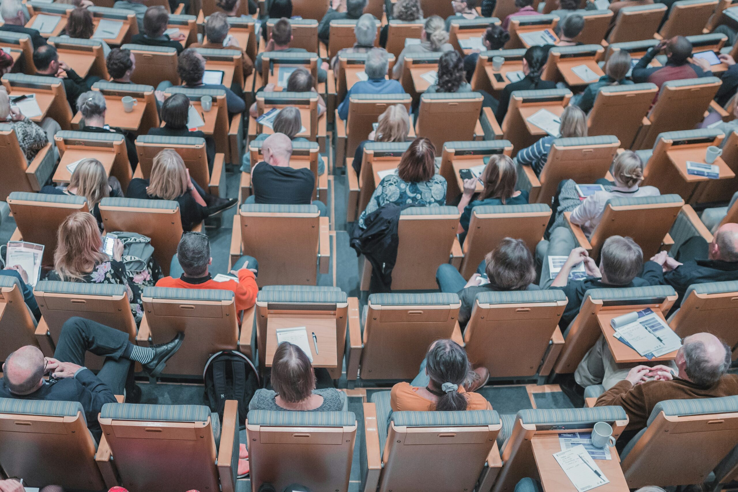 a high-angle photo of students sitting in a university lecture hall | education, university and public sector SaaS ERP solutions