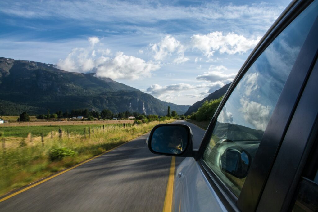 image of car driving through the mountains | AOX