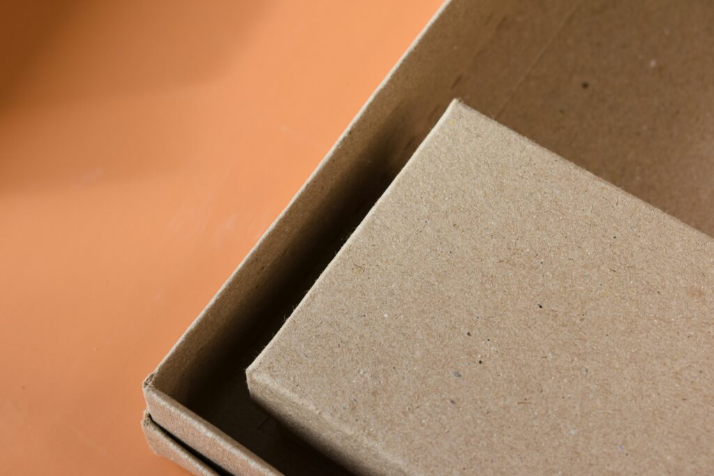 couple of cardboard boxes on an orange background | Green Bay Packaging