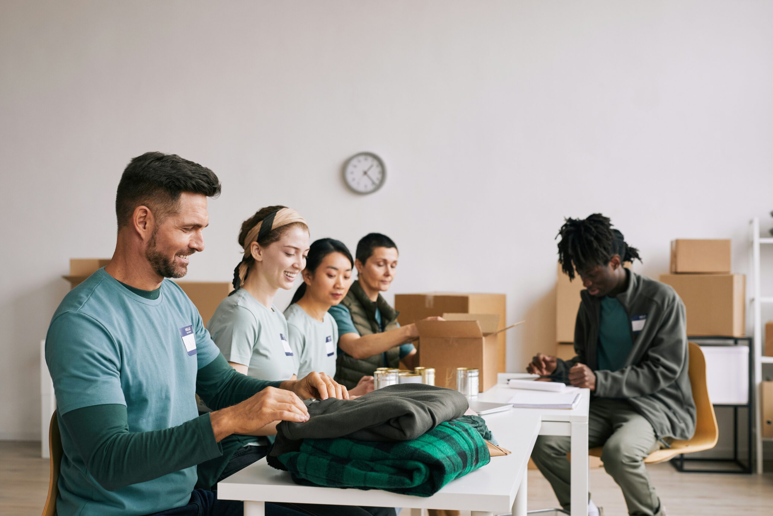 a diverse group of people prepare supplies for donations | DATABASICS and Sage Intacct-powered JMT Consulting partner for non-profit efficiency