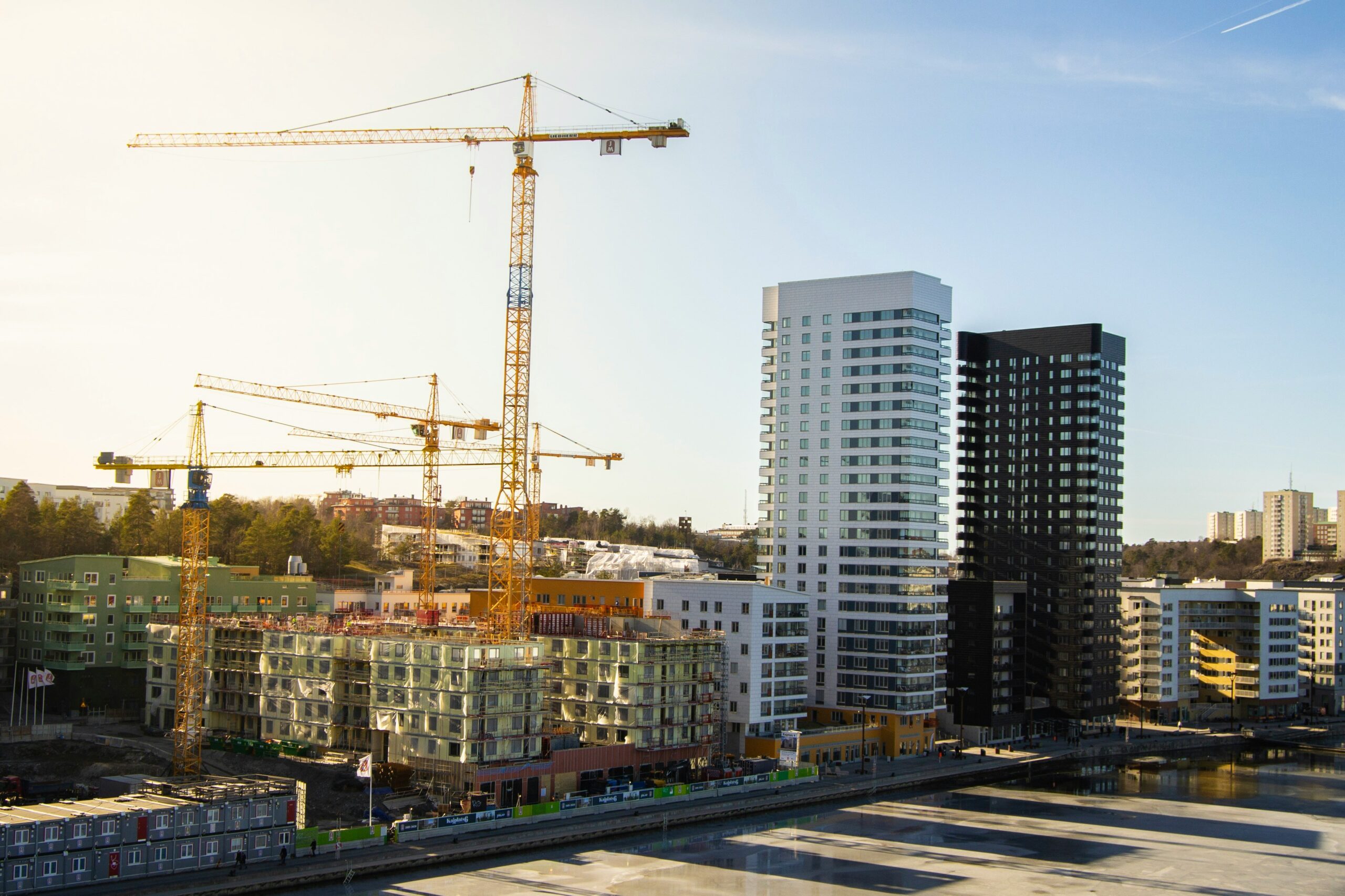 building developments next to a yellow crane