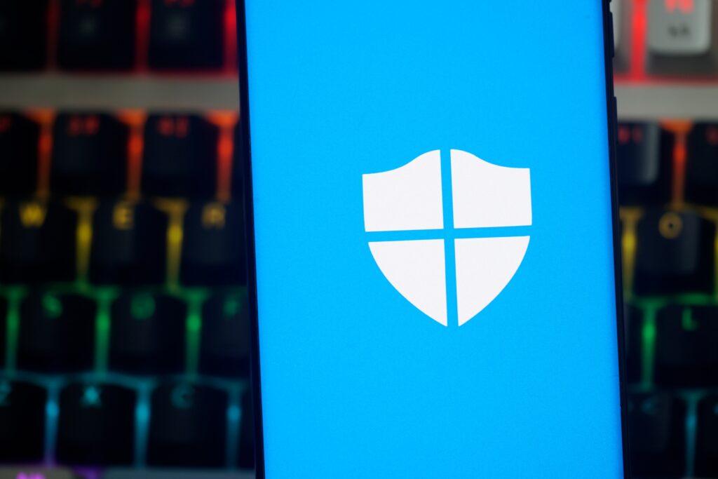Microsoft Defender for Office 365 log displayed on a phone in front of a keyboard.