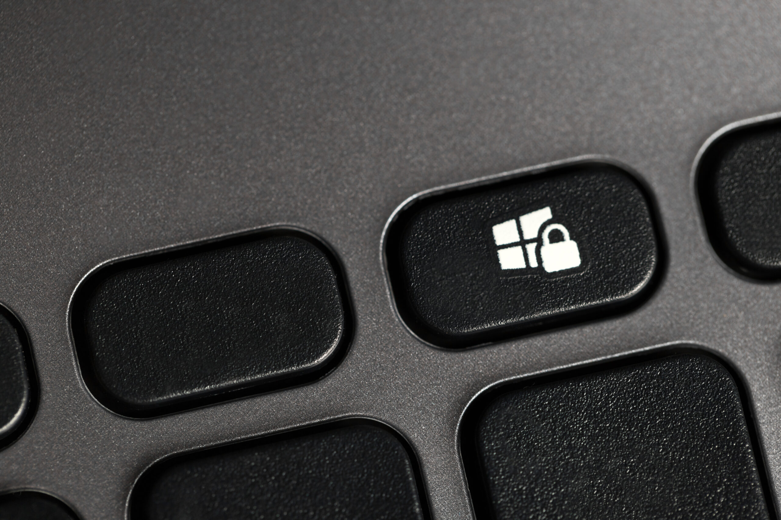 Keyboard with a key that shows a Microsoft logo with a lock over it