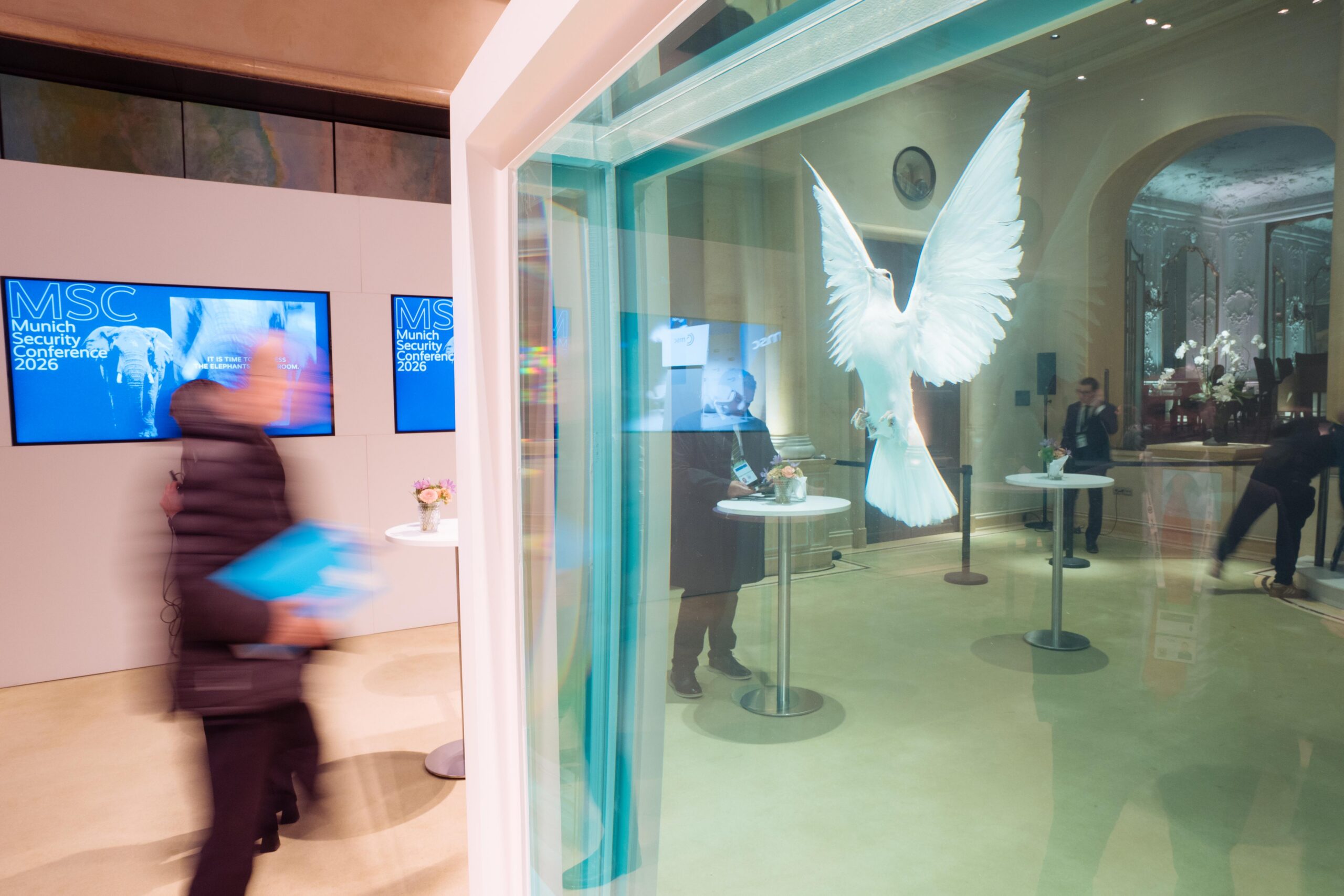 Munich Security Conference 2026 venue interior with MSC screens and white dove installation, photographed by Jens Hartmann for MSC.