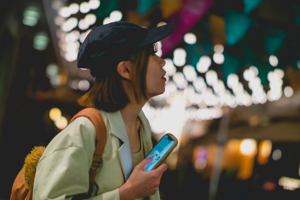 Woman holding a cellphone Tokyo _ KDDI billing transformation