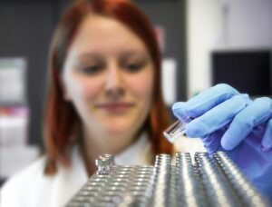 A woman in a lab with test tubes