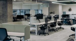 Empty enterprise office environment with desks and workstations, representing business operations, workflows, and organizational structure tied to unrealized AI value.