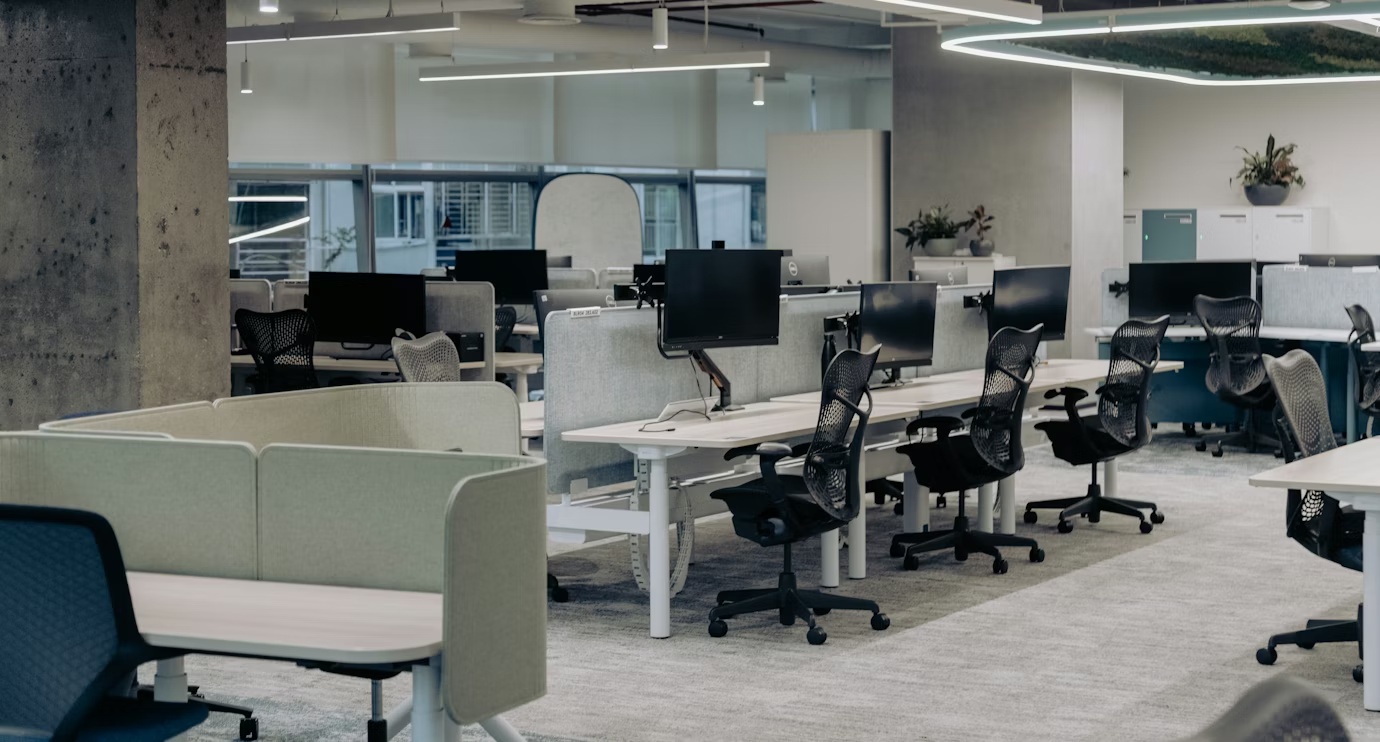 Empty enterprise office environment with desks and workstations, representing business operations, workflows, and organizational structure tied to unrealized AI value.