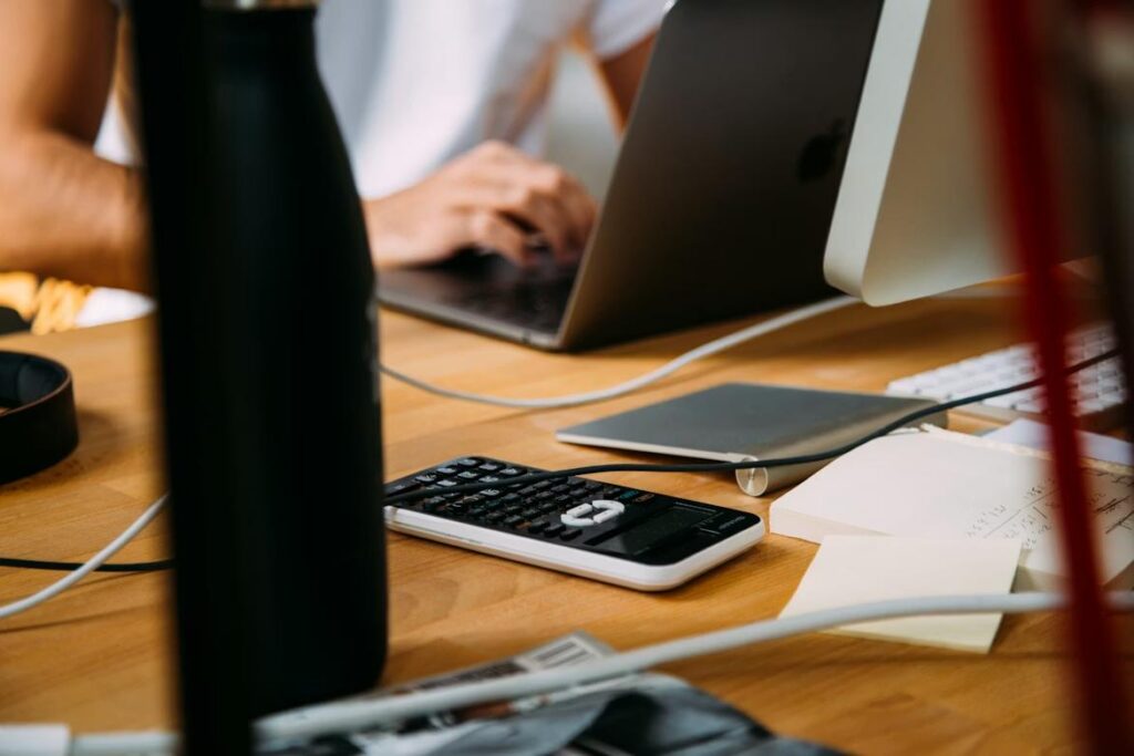 Finance professional working on a laptop reviewing data, representing AI in quote-to-cash workflows and finance processes.