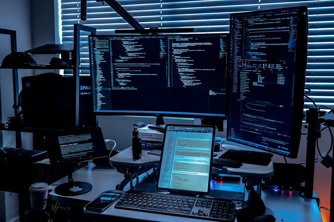 Enterprise IT monitoring environment with multiple screens displaying system data, representing SAP security patching and authorization risk management.