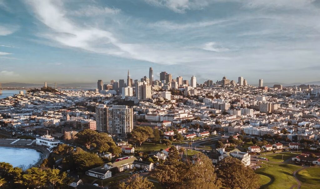 San Francisco skyline under a blue sky, representing Beacon.li’s AI platform for enterprise software implementation.