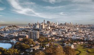 San Francisco skyline under a blue sky, representing Beacon.li’s AI platform for enterprise software implementation.