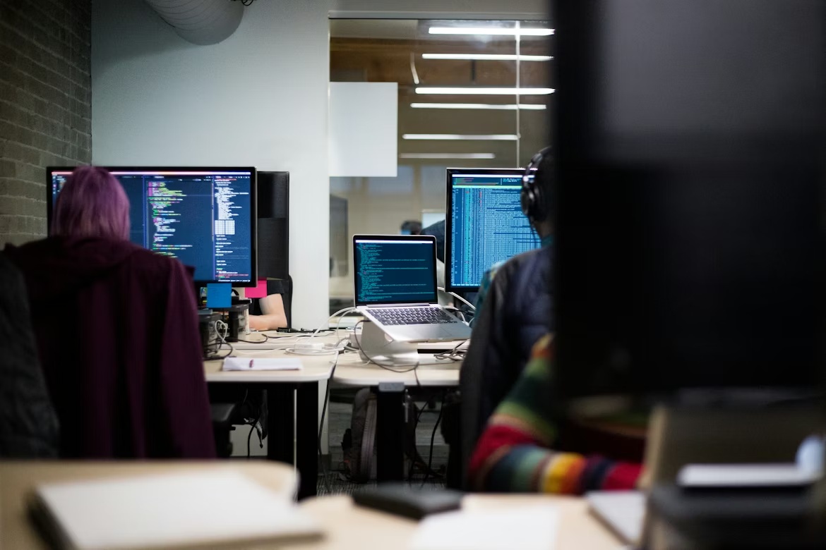 Software developers working at laptops, representing SAP Security Patch Day May 2026 risks across developer tooling and software supply chains.