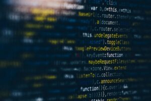 Close-up of JavaScript code on a dark screen representing the AI and software layer behind Epicor Prism's vertical agents in Epicor Kinetic and Prophet 21 ERP