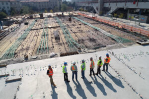 Construction professionals review a large building site, reflecting Sage Intacct Construction and construction ERP operations.