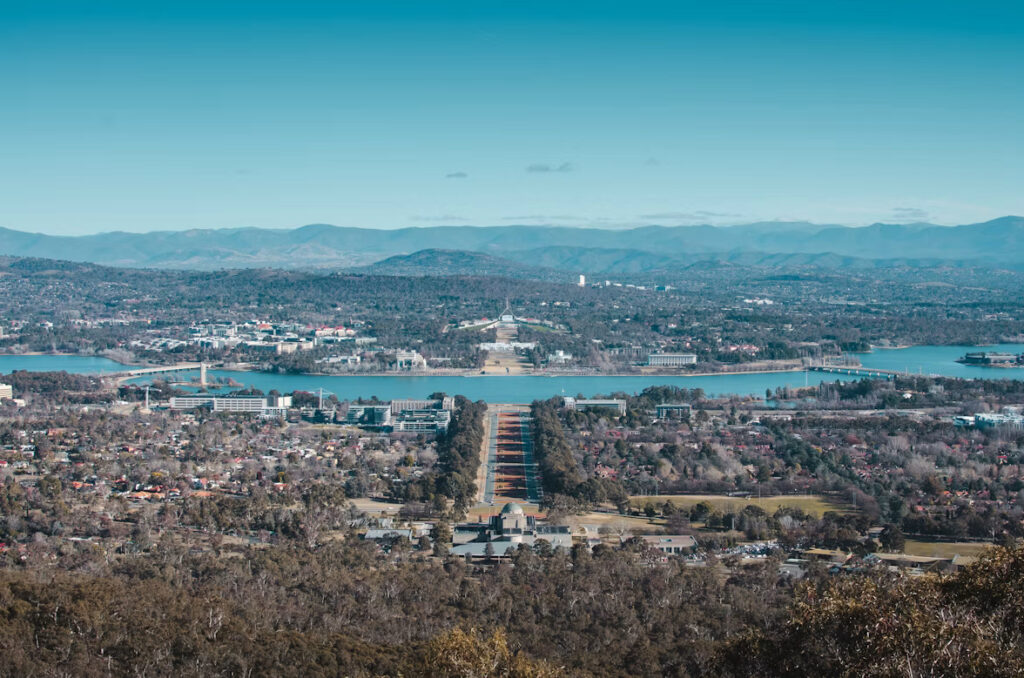 Aerial view of Canberra’s government precinct, Australia, with the city and surrounding hills in the distance
