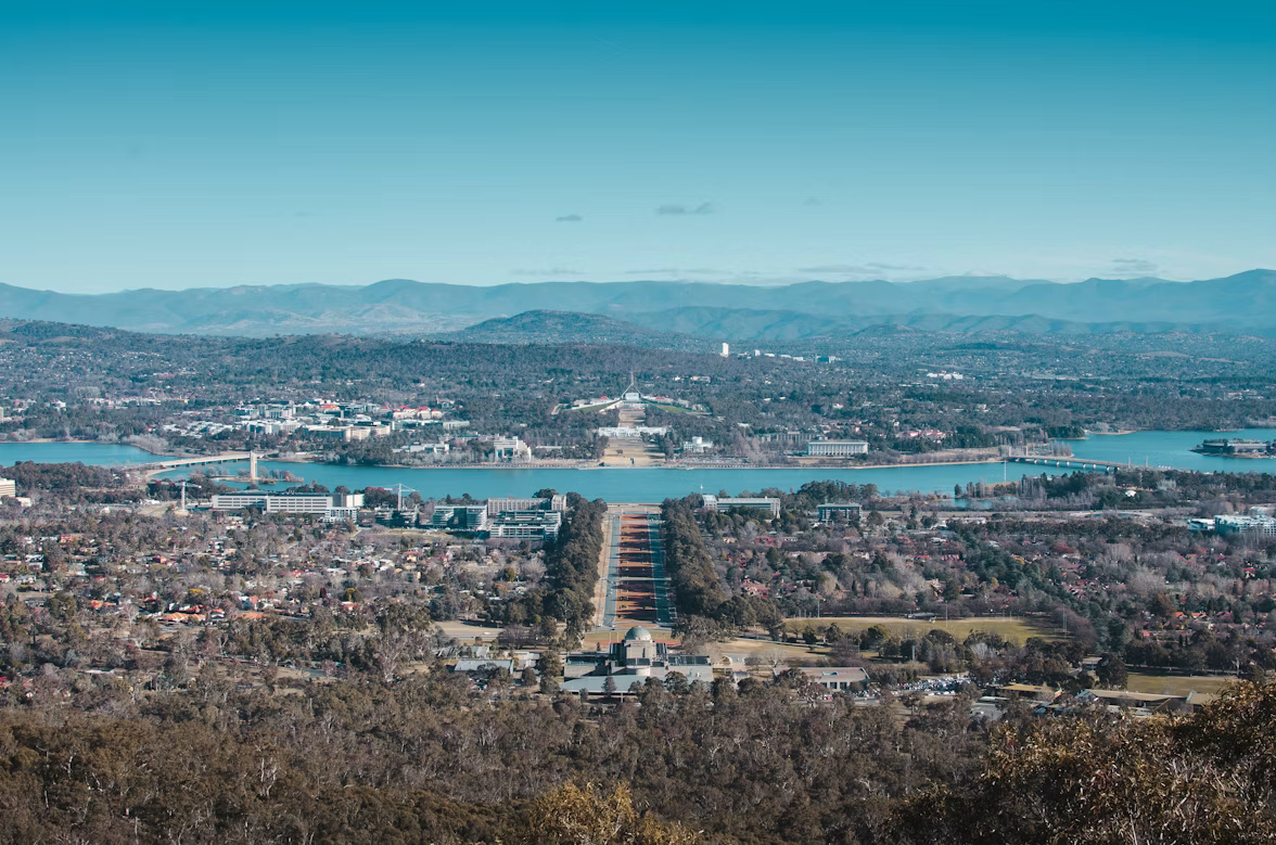 Aerial view of Canberra’s government precinct, Australia, with the city and surrounding hills in the distance
