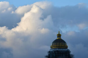 Ornate government building dome beneath a cloud-filled sky in Europe